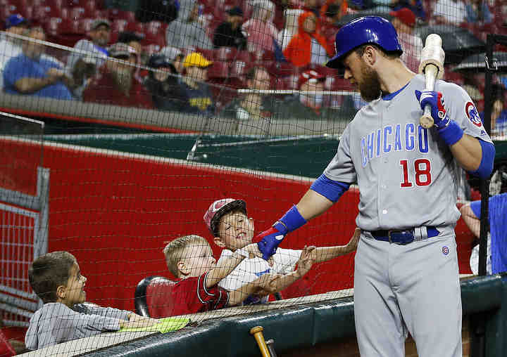 Chicago Cubs left fielder Ben Zobrist (18) first bumps with young fans behind the plate before the first inning of the MLB National League game between the Cincinnati Reds and the Chicago Cubs at Great American Ball Park in downtown Cincinnati on Friday, May 18, 2018. After three innings the Cubs led 4-0.  (Sam Greene / The Cincinnati Enquirer)